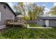 Exterior view of the home featuring a deck, detached garage and grassy yard at 4818 Guilford Ave, Indianapolis, IN 46205