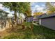 Relaxing backyard space with mature trees, lounge chairs and privacy fence at 4818 Guilford Ave, Indianapolis, IN 46205