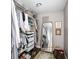 Spacious closet with hanging racks, storage drawers, and full-length mirror at 4818 Guilford Ave, Indianapolis, IN 46205
