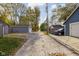 Long driveway leading to garages with a car parked on the side at 4818 Guilford Ave, Indianapolis, IN 46205
