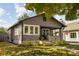 Charming gray home with inviting front porch and nicely landscaped front yard at 4818 Guilford Ave, Indianapolis, IN 46205