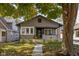 Charming home showcasing a landscaped front yard, inviting porch and traditional architectural design at 4818 Guilford Ave, Indianapolis, IN 46205