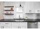 Stylish kitchen features subway tile backsplash, open shelving and stainless steel appliances at 4818 Guilford Ave, Indianapolis, IN 46205