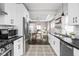 Bright kitchen flows into the dining area, showcasing stainless steel appliances and updated cabinets at 4818 Guilford Ave, Indianapolis, IN 46205