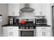 Kitchen boasts modern appliances, white cabinetry, and a functional layout for cooking and entertaining at 4818 Guilford Ave, Indianapolis, IN 46205