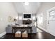 Bright living room featuring a fireplace, large windows, and comfortable seating at 4818 Guilford Ave, Indianapolis, IN 46205