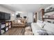 Relaxing living room with hardwood floors, comfortable seating, and brick accents at 4818 Guilford Ave, Indianapolis, IN 46205
