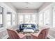 Bright sunroom filled with natural light, featuring stylish seating and serene ambiance at 4818 Guilford Ave, Indianapolis, IN 46205