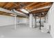 Partially finished basement featuring exposed ceiling, painted concrete floors, toilet and water heater at 488 N 24Th Ave, Beech Grove, IN 46107