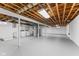 Unfinished basement with exposed wood ceiling, updated mechanicals, laundry, concrete flooring and a blank canvas for customization at 488 N 24Th Ave, Beech Grove, IN 46107