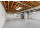 Spacious unfinished basement with exposed wood ceiling, painted concrete floor, and plenty of room for storage or customization at 488 N 24Th Ave, Beech Grove, IN 46107