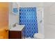 Bathroom featuring a new vanity, tile flooring, shower head and blue patterned shower curtain at 488 N 24Th Ave, Beech Grove, IN 46107