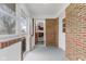 Enclosed porch with brick accents and access to the home's interior at 488 N 24Th Ave, Beech Grove, IN 46107