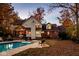 Backyard with a pool, patio and view of the home, surrounded by colorful foliage at 5015 Watersite Cir, Indianapolis, IN 46254