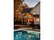 View of screened-in porch and deck, surrounded by beautiful autumn foliage and overlooking pool at 5015 Watersite Cir, Indianapolis, IN 46254