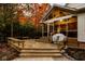 Inviting wooden deck with seating, leads to the home's screened in porch, overlooking a picturesque backyard at 5015 Watersite Cir, Indianapolis, IN 46254