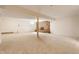 Expansive finished basement with plush carpeting, a cozy brick fireplace, and support beams at 5015 Watersite Cir, Indianapolis, IN 46254