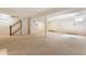 Spacious finished basement featuring neutral carpeting, white walls, and ample open space for various activities at 5015 Watersite Cir, Indianapolis, IN 46254