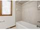 Bathroom with a tub and shower combo and tiled walls at 5015 Watersite Cir, Indianapolis, IN 46254