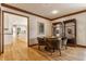 Dining area with hardwood floors, decorative shelving, and a view into the kitchen at 5015 Watersite Cir, Indianapolis, IN 46254