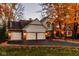 Charming home with a three car garage, brick accents and a well manicured yard, surrounded by beautiful fall foliage at 5015 Watersite Cir, Indianapolis, IN 46254
