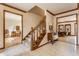 Well-lit foyer with a carpeted staircase and views into the living spaces of the home at 5015 Watersite Cir, Indianapolis, IN 46254