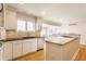 Spacious kitchen with white cabinets, an island with seating, and modern appliances, open floor plan at 5015 Watersite Cir, Indianapolis, IN 46254