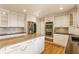 Stylish kitchen with white cabinetry, granite countertops, stainless steel appliances, and eat-in island at 5015 Watersite Cir, Indianapolis, IN 46254