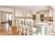 Bright kitchen with white cabinets, barstool seating at the island and stainless steel appliances at 5015 Watersite Cir, Indianapolis, IN 46254