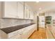 Modern kitchen featuring white cabinets, stainless steel appliances, and a sleek backsplash at 5015 Watersite Cir, Indianapolis, IN 46254