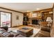 Cozy living room with a brick fireplace, built-in bookshelves, and sliding doors to the outdoor patio at 5015 Watersite Cir, Indianapolis, IN 46254