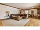 Spacious living room with hardwood floors, a leather sectional sofa, and natural light at 5015 Watersite Cir, Indianapolis, IN 46254