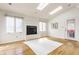 Bright living room with a fireplace, skylights, hardwood floors and a door leading to the outside at 5015 Watersite Cir, Indianapolis, IN 46254