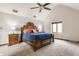 Spacious main bedroom featuring a high ceiling, carpeted floors, and a ceiling fan at 5015 Watersite Cir, Indianapolis, IN 46254