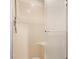 Updated shower with a handheld shower head and frosted shower door at 5015 Watersite Cir, Indianapolis, IN 46254
