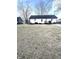 Exterior view of home showing a large backyard with mature trees at 504 S Main St, Waldron, IN 46182