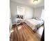 Bright bedroom with a large window, hardwood floors and neutral walls, perfect for relaxation at 504 S Main St, Waldron, IN 46182