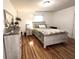 Cozy bedroom with hardwood floors and a comfortable bed at 504 S Main St, Waldron, IN 46182