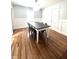 Elegant dining room with wood floors and modern chandelier at 504 S Main St, Waldron, IN 46182