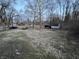 Exterior view of the backyard with trees surrounding the back of the property at 5202 Riverview Dr, Indianapolis, IN 46208