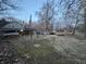 View of the yard with a home in the background surrounded by various trees at 5202 Riverview Dr, Indianapolis, IN 46208