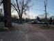 View of the exterior of a home surrounded by trees, parked vehicles and a mailbox at 5202 Riverview Dr, Indianapolis, IN 46208