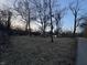 View of a property and home partially obscured by trees and street lighting at 5202 Riverview Dr, Indianapolis, IN 46208