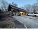 View of a detached two-car garage with an overhead covering and white pickup truck parked near it at 5202 Riverview Dr, Indianapolis, IN 46208