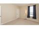 Serene bedroom with neutral carpet and paint, window with blinds and curtains at 5344 Misthaven Ln, Greenwood, IN 46143