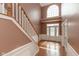 Bright foyer with hardwood floors, staircase, and a large window above the entrance at 5344 Misthaven Ln, Greenwood, IN 46143