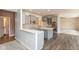 Modern kitchen boasts gray cabinets, quartz countertops, herringbone backsplash, stainless appliances, and a spacious island at 5344 Misthaven Ln, Greenwood, IN 46143