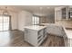 Bright kitchen features a large island with storage, gray cabinets, and stainless steel appliances at 5344 Misthaven Ln, Greenwood, IN 46143