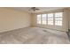 Spacious living room with plush carpet, ceiling fan, and bright natural light at 5344 Misthaven Ln, Greenwood, IN 46143