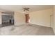 Open living room with plush carpet, ceiling fan, and view to the kitchen at 5344 Misthaven Ln, Greenwood, IN 46143